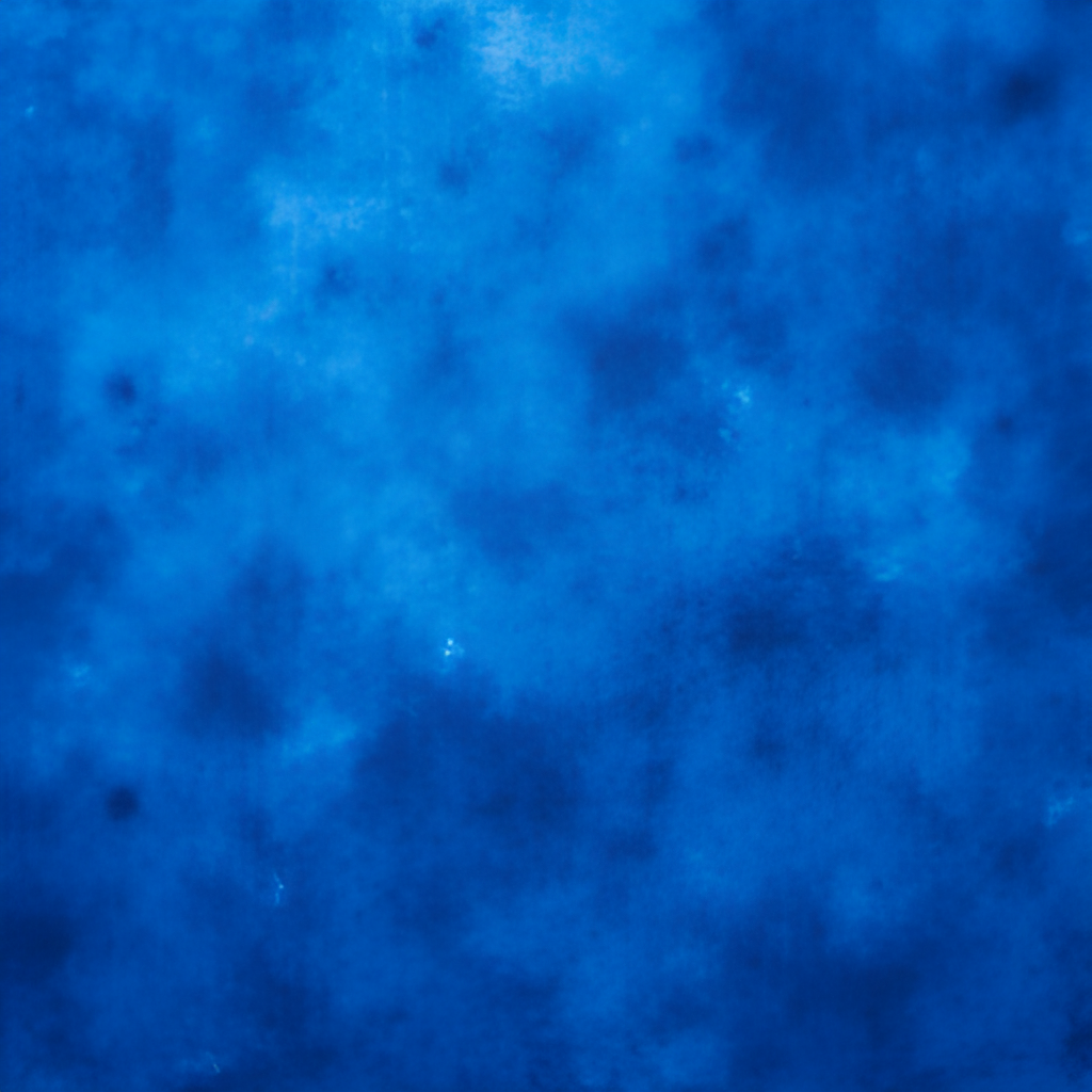 A vibrant close-up image of indigo-dyed fabric with a rich, deep blue color, showcasing the beauty of the dye.